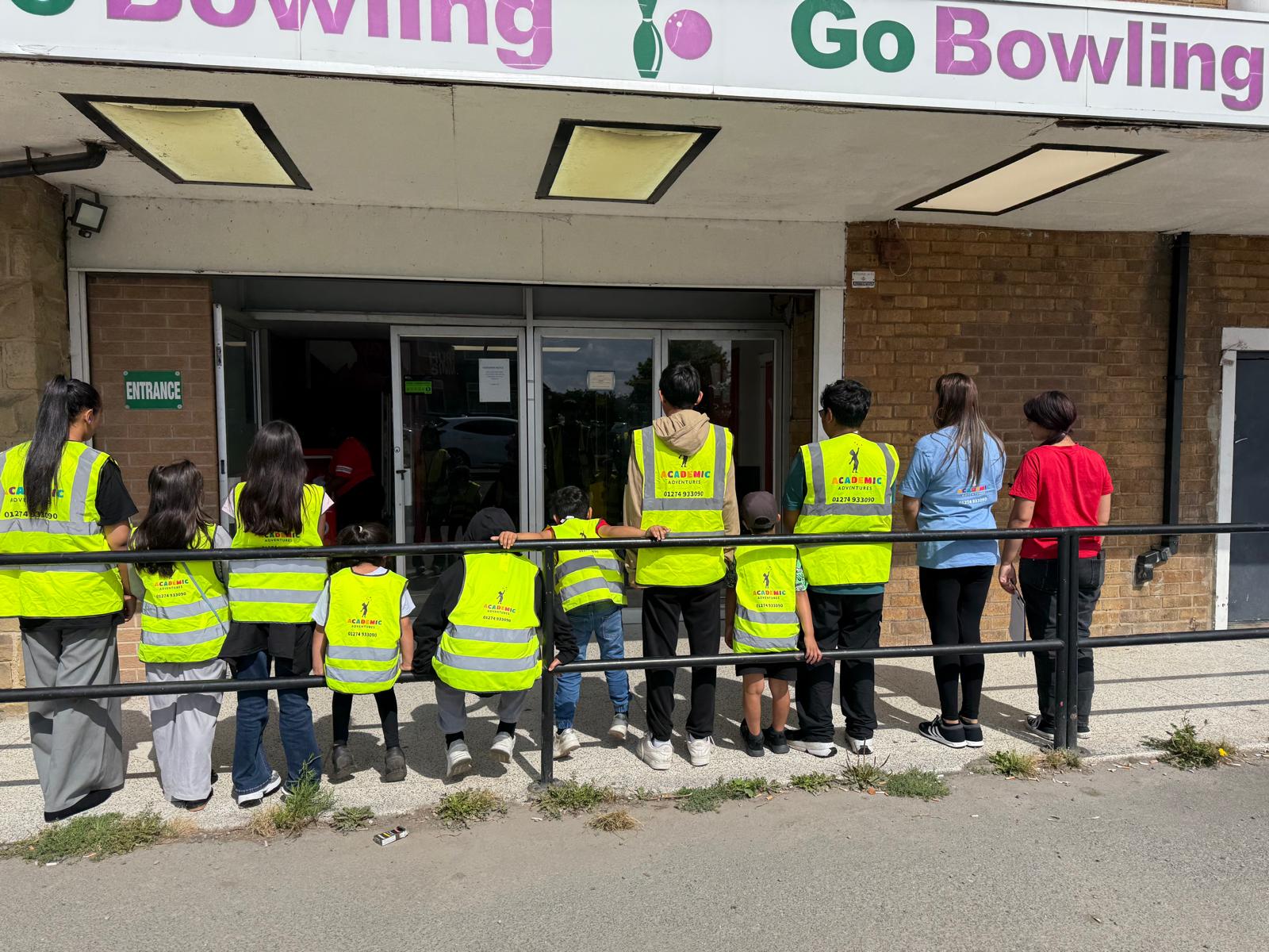 Academic Adventures children and staff arriving together in branded high-visibility vests